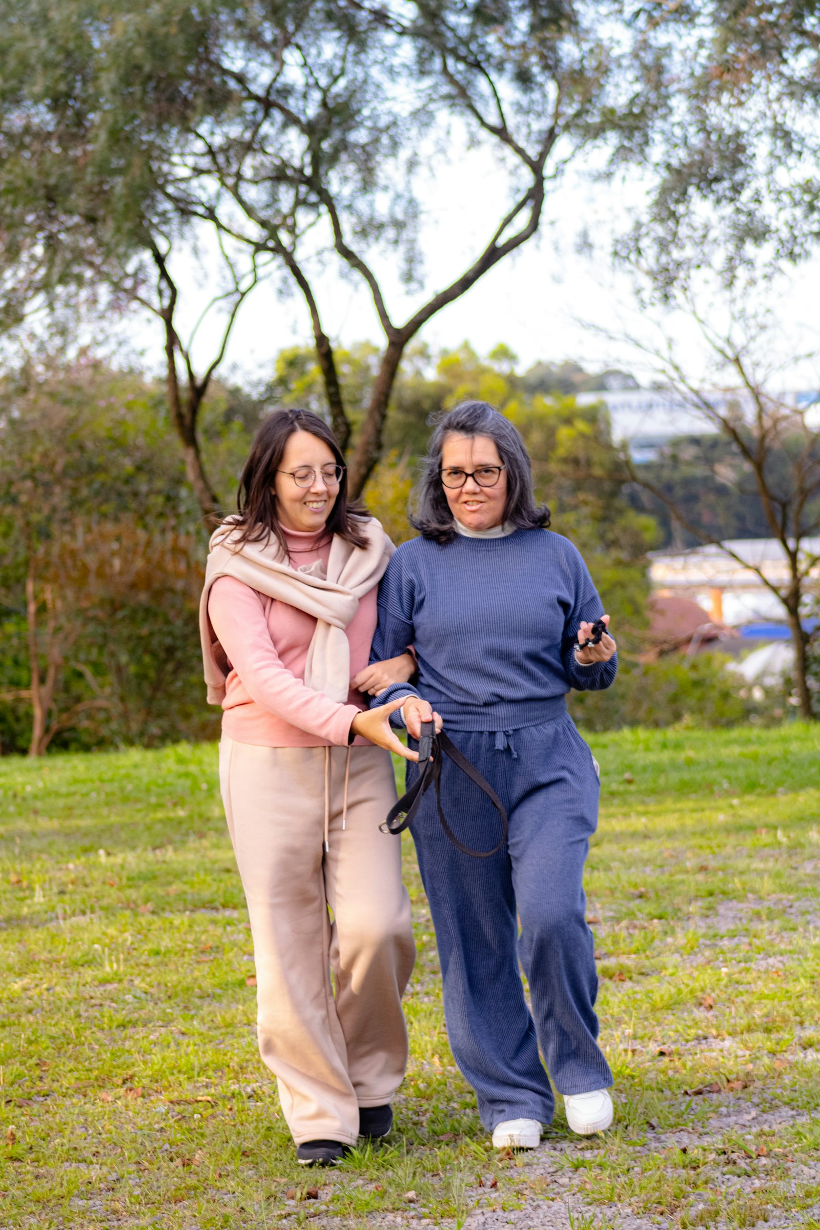 Two older women walking together arm in arm